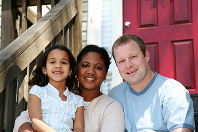 Family of three siting on stairs