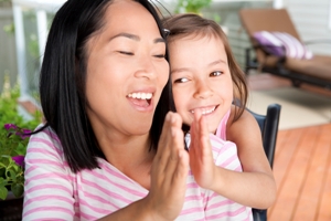 Mom and her child high-fiving.