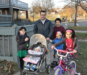 Refugee family outside.