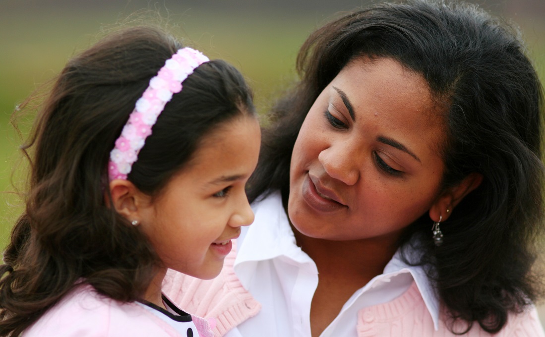 Woman talking to little girl.