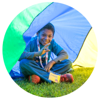 Child playing under parachute