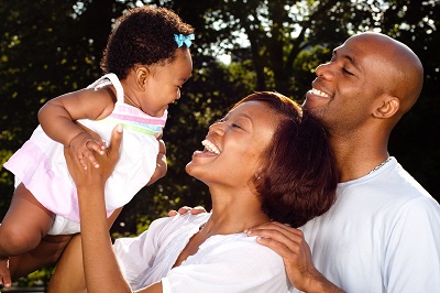 Family laughing with infant