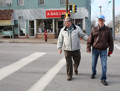 Men walking across street.