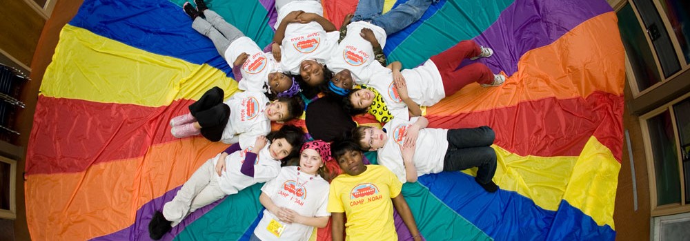 Children and staff playing parachute 