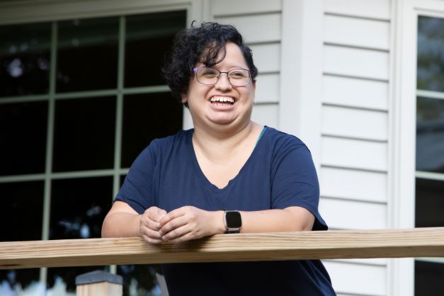 Rosa smiles on porch.