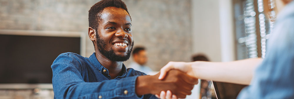 Man shaking someone's hand in an office