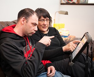 Two adults using an ipad