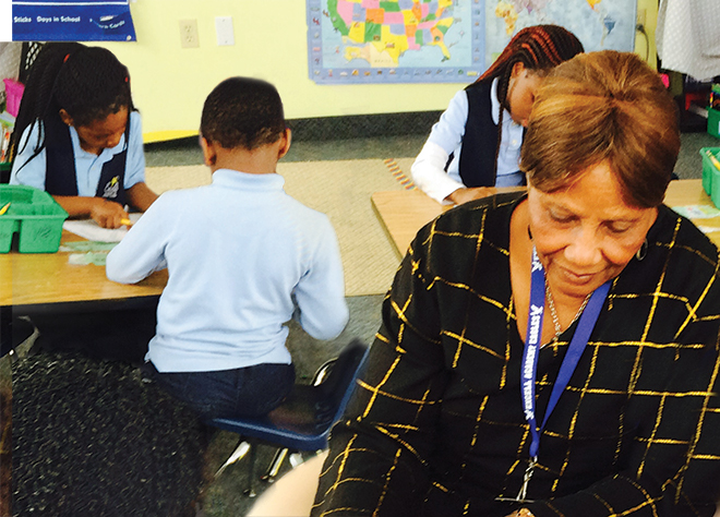 Grandma Charlotte with kids at desk