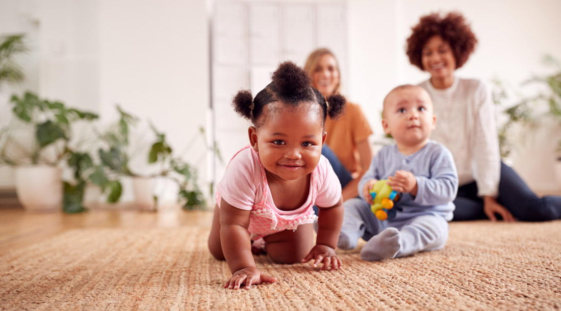 Baby crawling with family