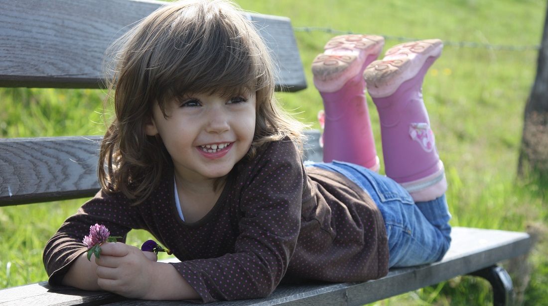 girl smiling on bench