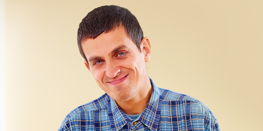 Man smiling at camera in a waiting room