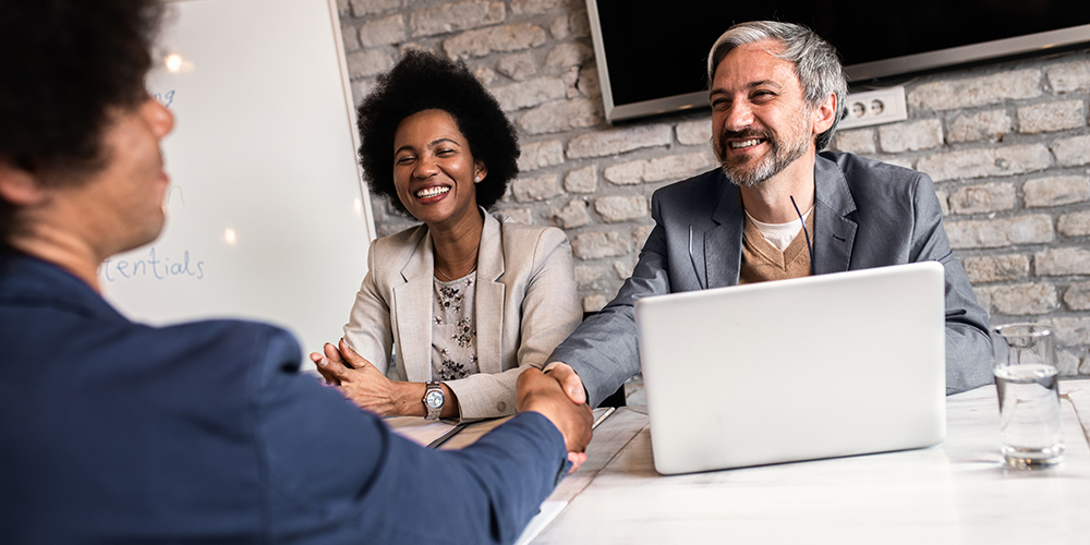 Three people at a table during an interview