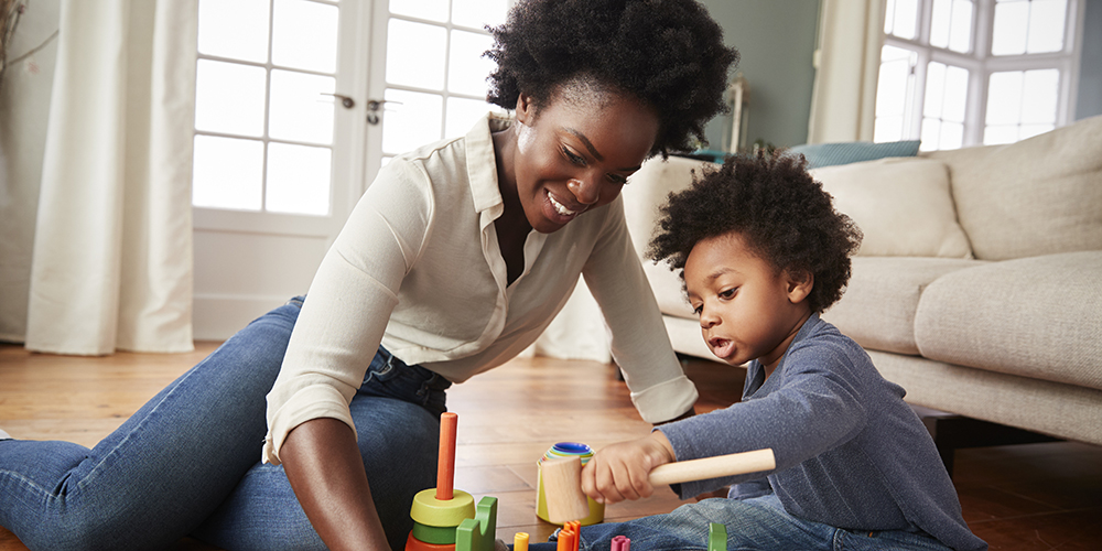 Mother and child playing together in a living room