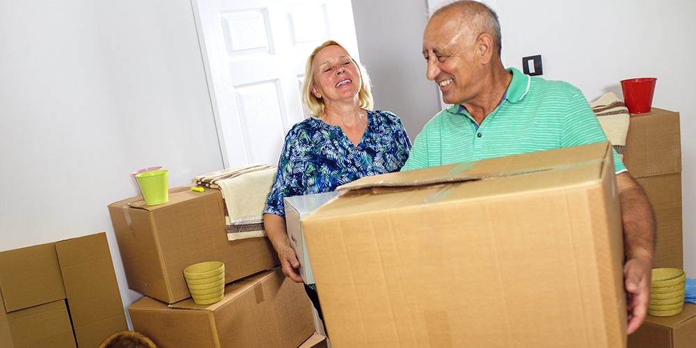 Couple moving into a house together and smiling