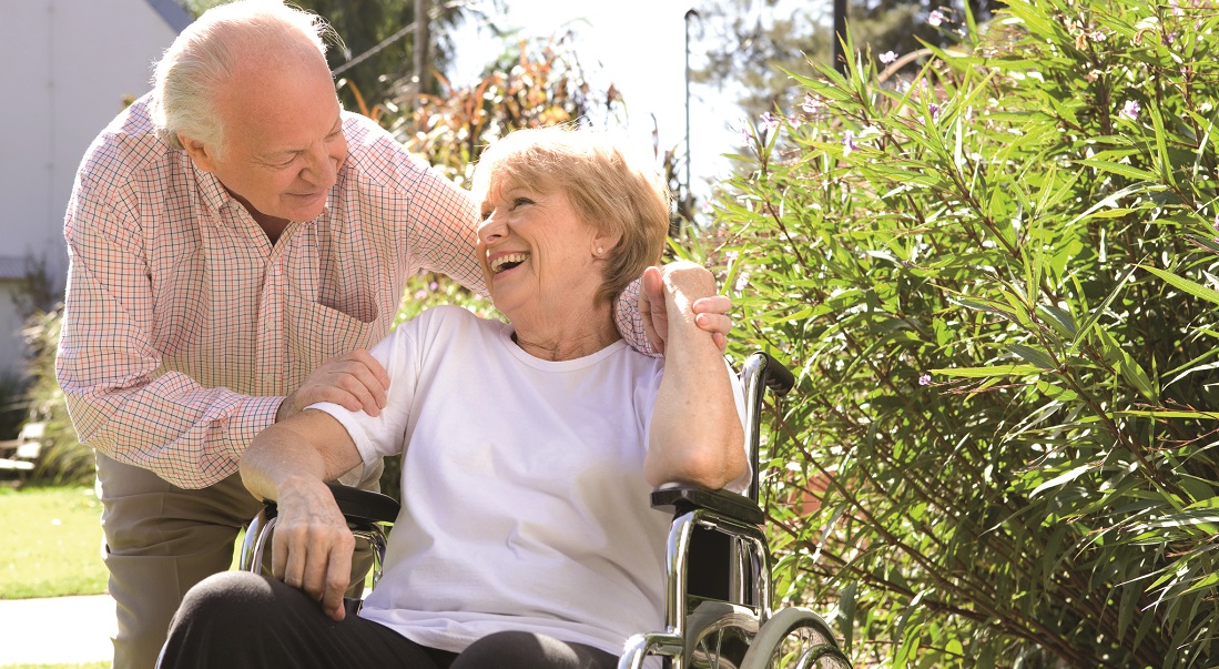 man smiling at woman in wheelchair