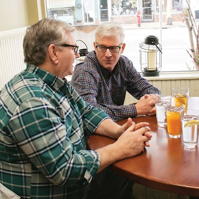 Two men talking at a table