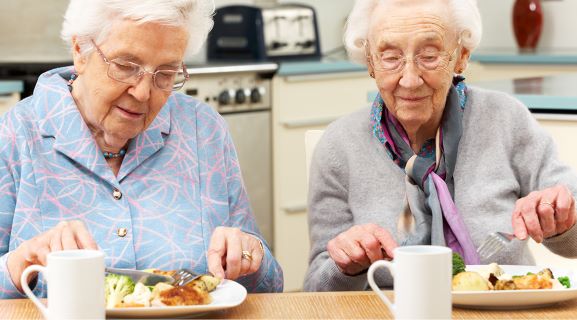 Older adults dinning on a LSS meals on wheels delivery.