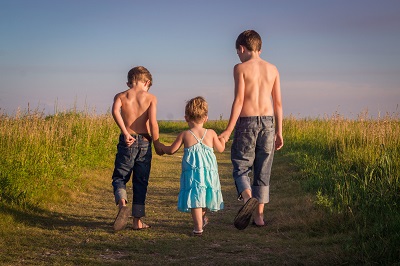 boys walking in field