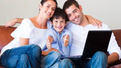 Family on couch with computer