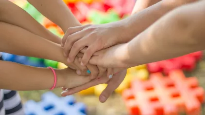 A group of hands gathered together