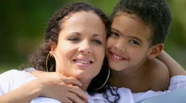 Woman smiling with boy.